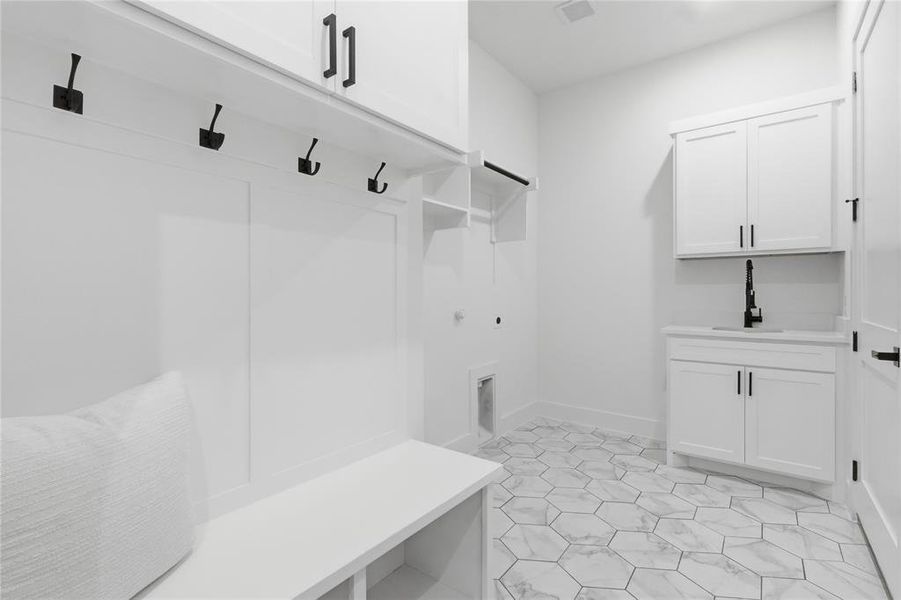 Mudroom with baseboards and a sink