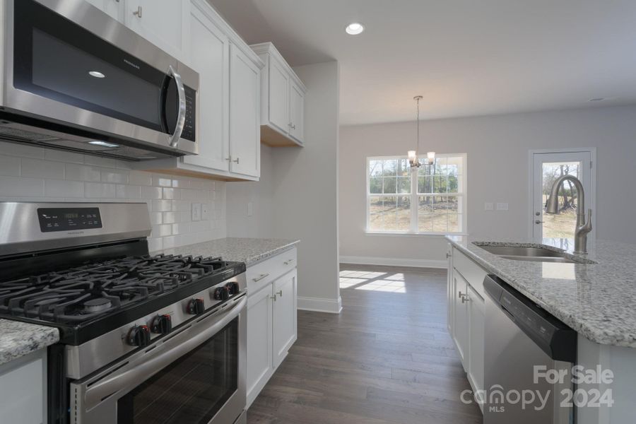 Kitchen into Breakfast Area. Photo representation. Colors and options will differ.