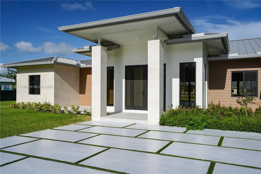 Front exterior of a new home in , Homestead, FL, highlighting curb appeal (Image 31).