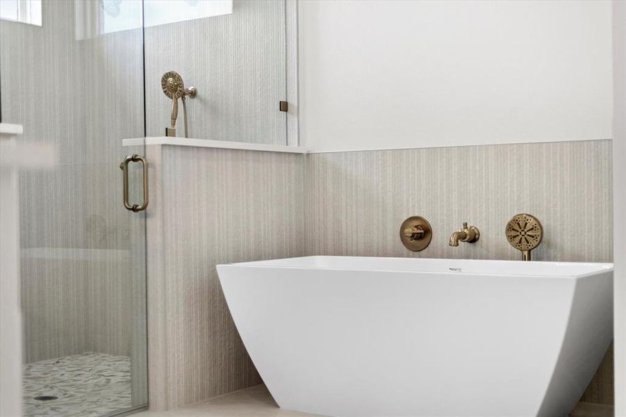 Bathroom with a freestanding tub and a shower stall Bathroom with a freestanding tub and a shower stall