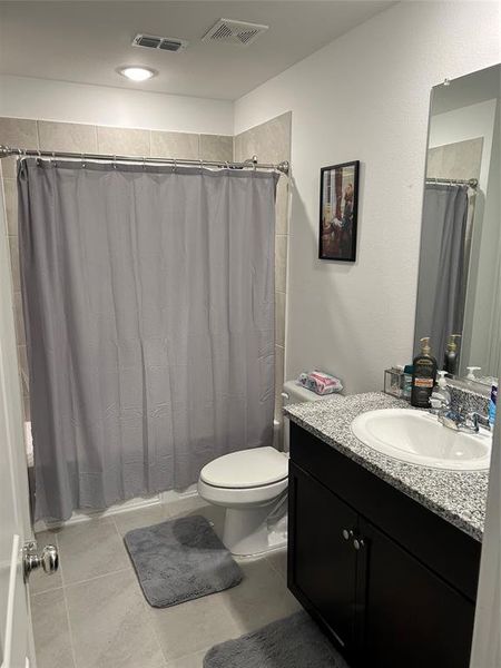 Bathroom with vanity, tile patterned floors, and toilet Bathroom with vanity, tile patterned floors, and toilet