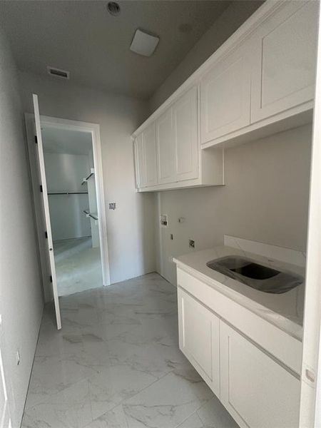 Primary closet conveniently connects to the utility room