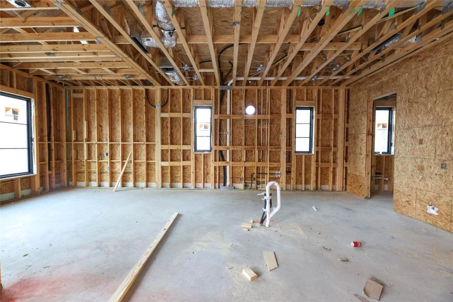 *Construction Progress Photo taken 11/20/25* Gourmet Kitchen offers large quartz island & backsplash, custom site-built cabinetry, designer selected fixtures, high end Thermador appliances & pot filler.