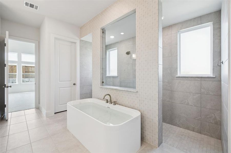 This beautiful owner's bath features our signature design with freestanding tub and walk through shower creating a spa like experience every day! This beautiful owner's bath features our signature design with freestanding tub and walk through shower creating a spa like experience every day!