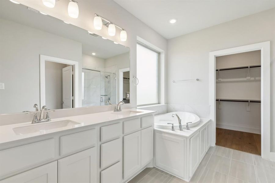 Bathroom with tile patterned flooring, vanity, and independent shower and bath