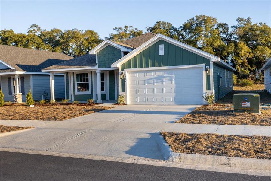 Front exterior of a new home in Briarwood, Alachua, FL, highlighting curb appeal (Image 19).