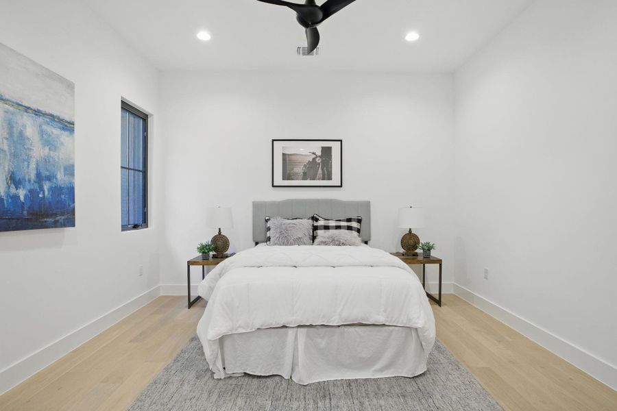 Bedroom with light wood-style flooring, recessed lighting, and baseboards