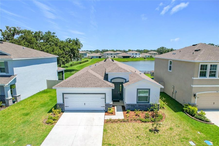 Front exterior of a new home in Farm at Varrea Villas, Plant City, FL, highlighting curb appeal (Image 26). Front exterior of a new home in Farm at Varrea Villas, Plant City, FL, highlighting curb appeal (Image 26).