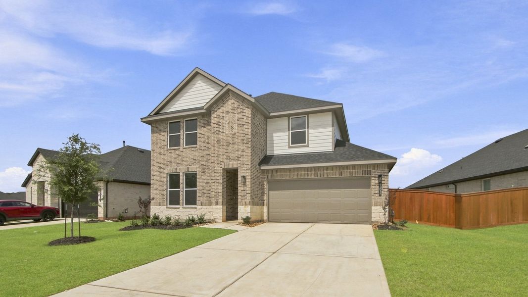 Front exterior of a new home in Mill Creek Estates, Magnolia, TX, highlighting curb appeal (Image 2). Front exterior of a new home in Mill Creek Estates, Magnolia, TX, highlighting curb appeal (Image 2).