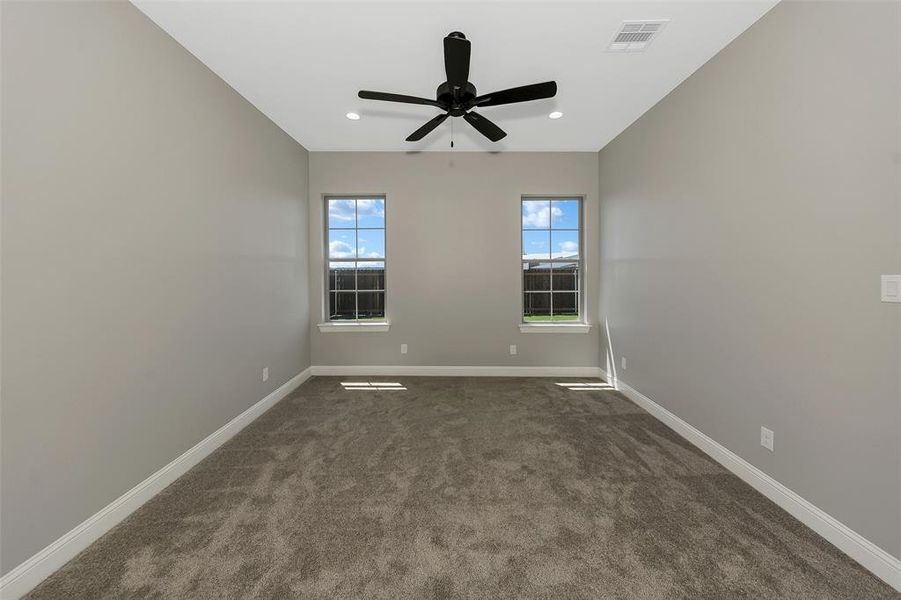 Unfurnished room with dark carpet, a ceiling fan, and recessed lighting
