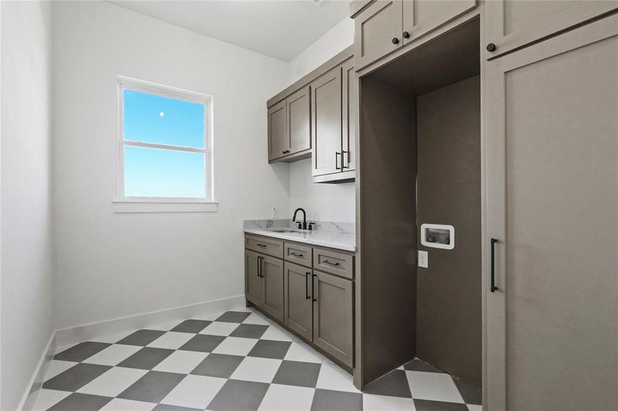 Laundry room with light flooring and washer hookup Laundry room with light flooring and washer hookup