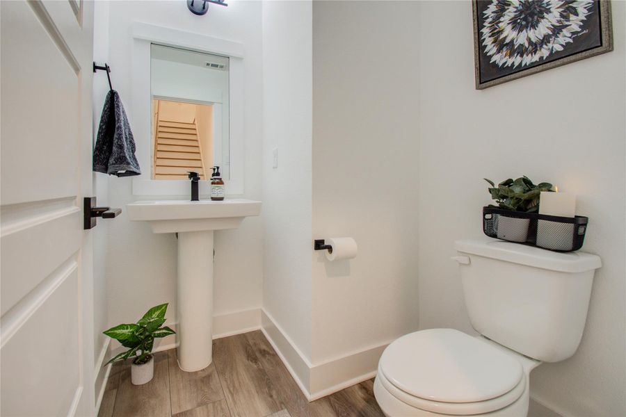 Powder room conveniently located between the second and the third floor. Photos from another community by the same builder, FINISHES & FLOOR PLAN WILL VARY! Ceiling fans are not included!