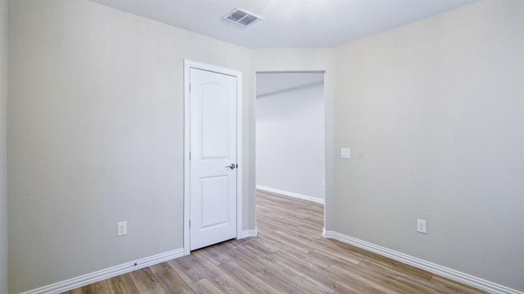 Spare room with baseboards and light wood-type flooring Spare room with baseboards and light wood-type flooring