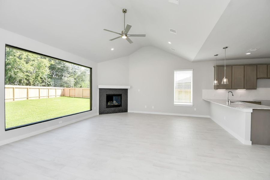 Take another glimpse into the heart of the home with this additional view of the family room—a sprawling space ready to accommodate all your gatherings. Sample photo of completed home with similar floor plan. Actual colors and selections may vary.