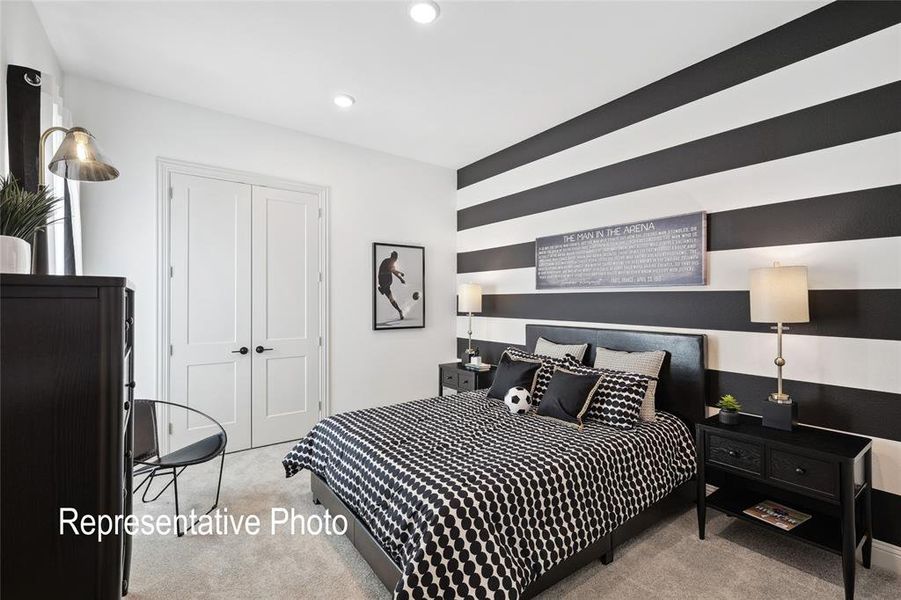 Bedroom featuring a black and white striped accent wall, recessed lighting, and light gray carpeting