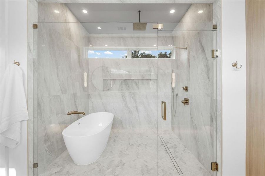 Full bath with a soaking tub and a marble finish shower