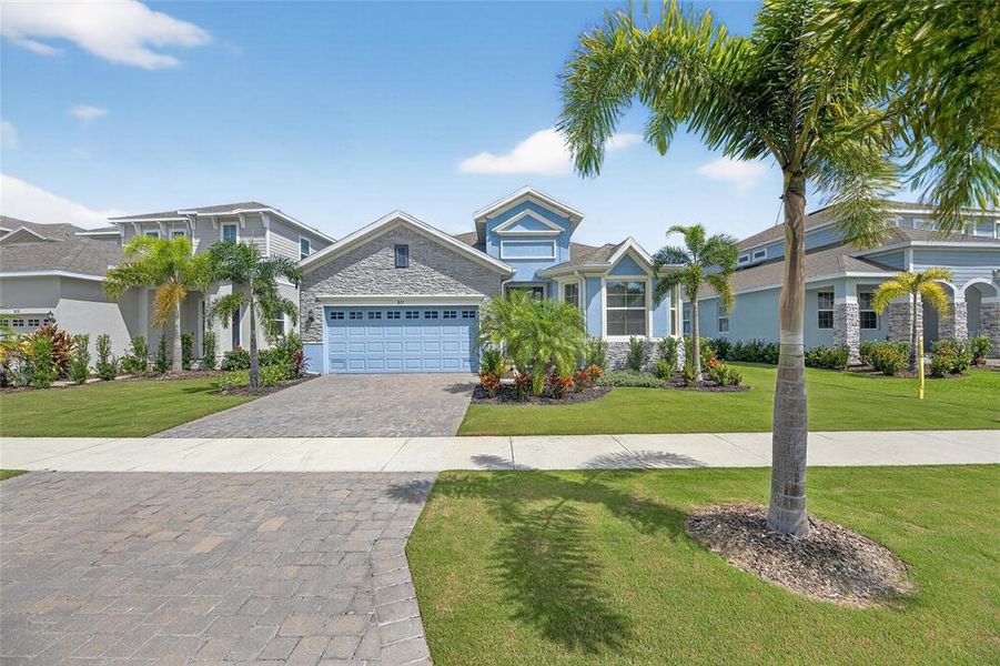 Front exterior of a new home in Marisol Pointe at MiraBay Florida Series, Apollo Beach, FL, highlighting curb appeal (Image 24).