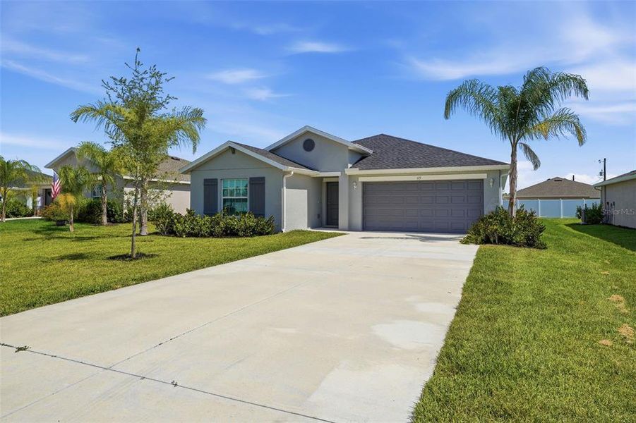 Front exterior of a new home in Rotonda Lakes, Rotonda West, FL, highlighting curb appeal (Image 2). Front exterior of a new home in Rotonda Lakes, Rotonda West, FL, highlighting curb appeal (Image 2).