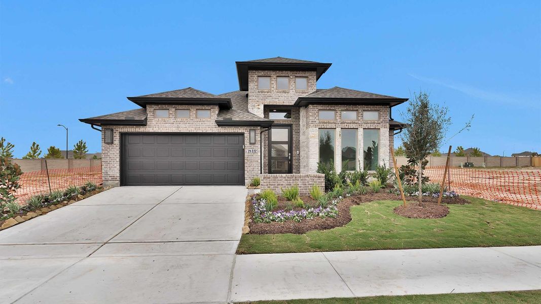 Front exterior of a new home in Bridgeland 50', Cypress, TX, highlighting curb appeal (Image 2). Front exterior of a new home in Bridgeland 50', Cypress, TX, highlighting curb appeal (Image 2).