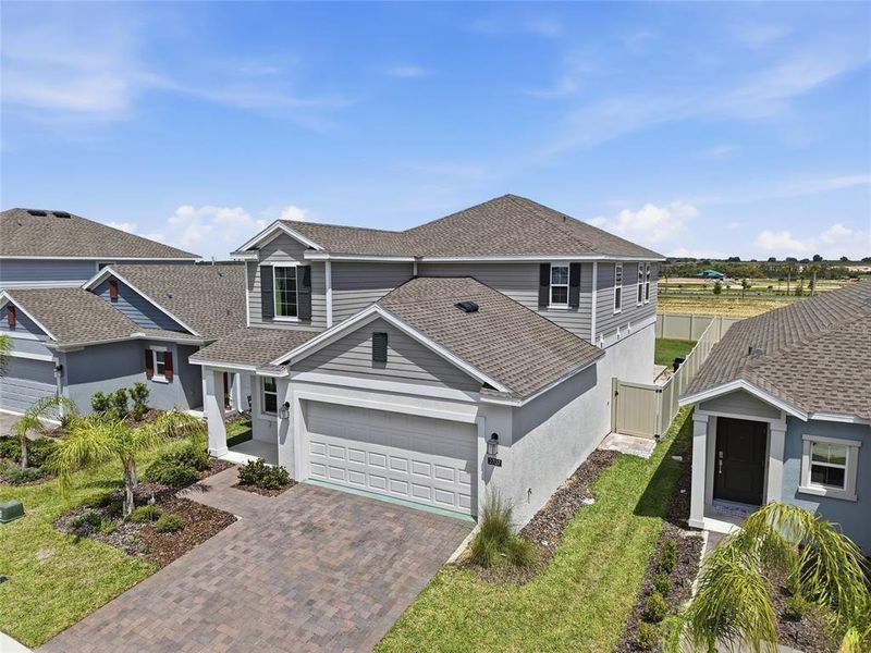 Front exterior of a new home in Wellness Ridge, Clermont, FL, highlighting curb appeal (Image 28).