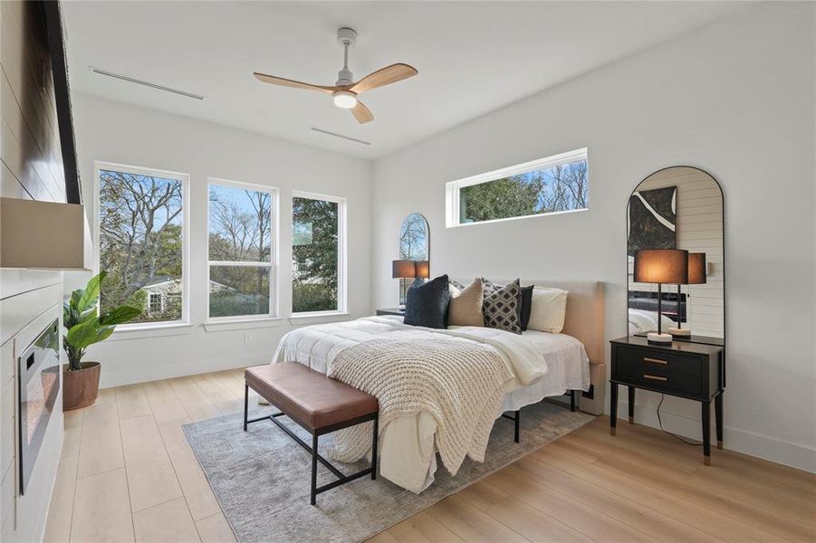 Bedroom with ceiling fan and light wood-style flooring Bedroom with ceiling fan and light wood-style flooring