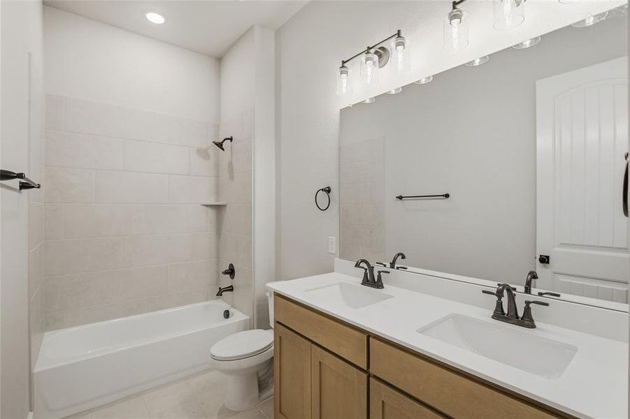 Full bath with double vanity, bathing tub / shower combination, light tile patterned floors, and recessed lighting
