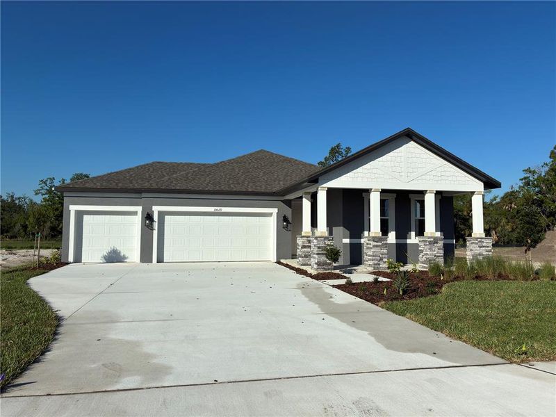 Front exterior of a new home in Oakfield Trails, Parrish, FL, highlighting curb appeal (Image 11). Front exterior of a new home in Oakfield Trails, Parrish, FL, highlighting curb appeal (Image 11).