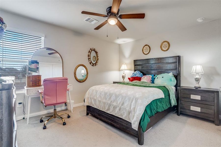 Bedroom with carpet flooring, ceiling fan, and a desk Bedroom with carpet flooring, ceiling fan, and a desk