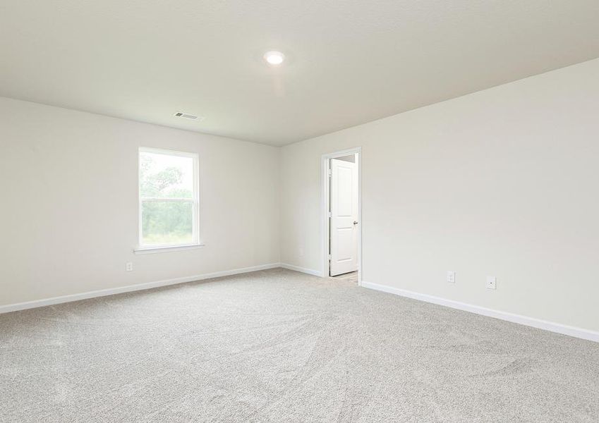 This spacious master bedroom is the perfect place to relax after a long day