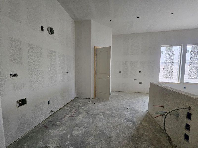 Open-concept space featuring drywall-ready walls and a concrete subfloor Open-concept space featuring drywall-ready walls and a concrete subfloor