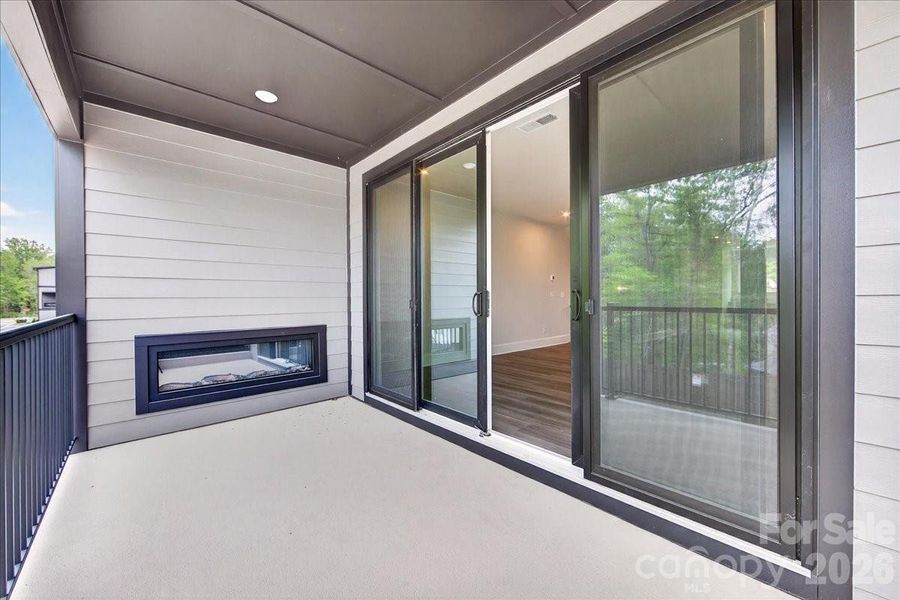 Covered outdoor living space with an electric fireplace