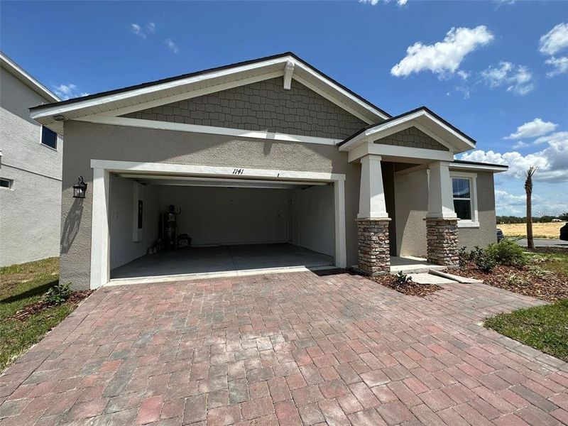 Front exterior of a new home in Soleil, Kissimmee, FL, highlighting curb appeal (Image 15).