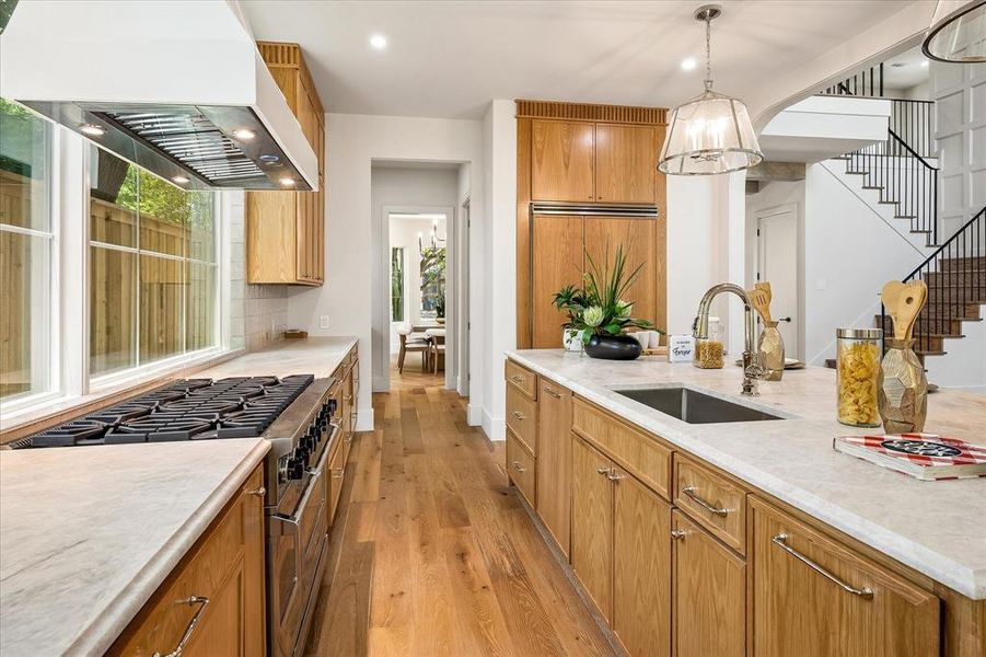 Professional range, island sink, Taj Mahal quartzite countertops Professional range, island sink, Taj Mahal quartzite countertops