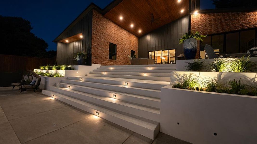 The exterior lighting, hardscaping, and landscaping on this home feel more custom than spec.  White lantana, purple sage, red yucca - heat tolerant and gorgeous.