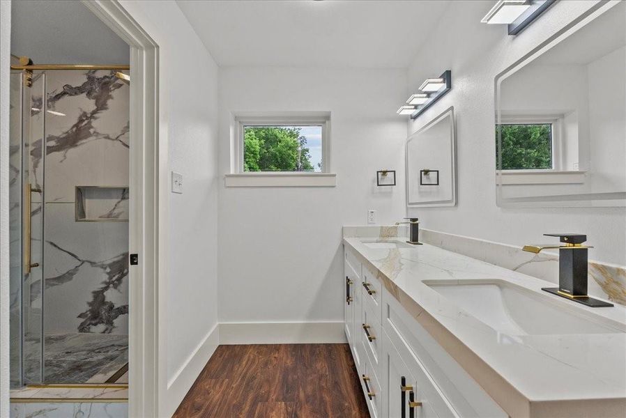 Spacious upstairs bath directly across from rooms three and four, featuring dual sinks and custom cabinetry.