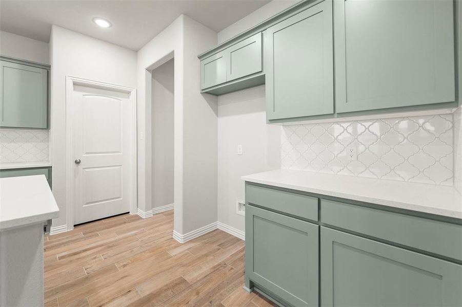 Laundry area featuring light wood-style floors, recessed lighting, and hookup for a washing machine Laundry area featuring light wood-style floors, recessed lighting, and hookup for a washing machine