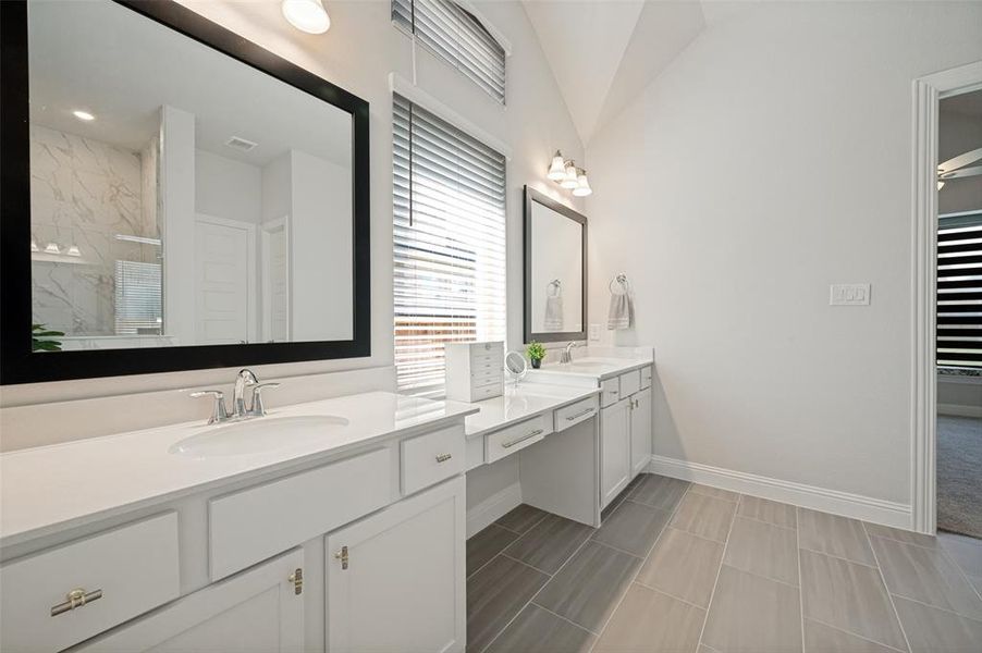 Enjoy a spa-like experience in this beautifully appointed primary bathroom featuring an extended dual-sink vanity with abundant counter space, elegant framed mirrors, and ample storage. The bright, neutral finishes create a clean and timeless look, while the spacious layout offers both comfort and functionality for everyday living. Thoughtfully designed for convenience, this luxurious bath provides the perfect complement to the private owner's retreat. Enjoy a spa-like experience in this beautifully appointed primary bathroom featuring an extended dual-sink vanity with abundant counter space, elegant framed mirrors, and ample storage. The bright, neutral finishes create a clean and timeless look, while the spacious layout offers both comfort and functionality for everyday living. Thoughtfully designed for convenience, this luxurious bath provides the perfect complement to the private owner's retreat.