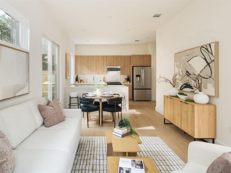 Open-concept living space with light wood-finish flooring