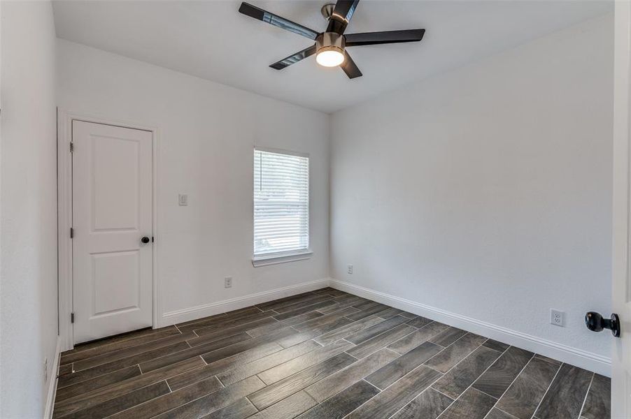 Empty room featuring wood tiled floors and ceiling fan Empty room featuring wood tiled floors and ceiling fan