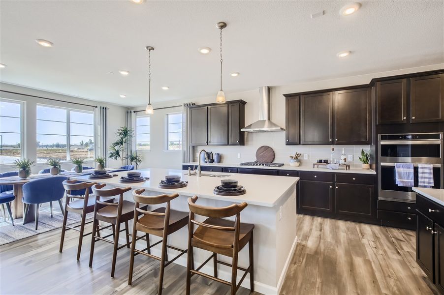 A kitchen with a dining table and chairs. A kitchen with a dining table and chairs.