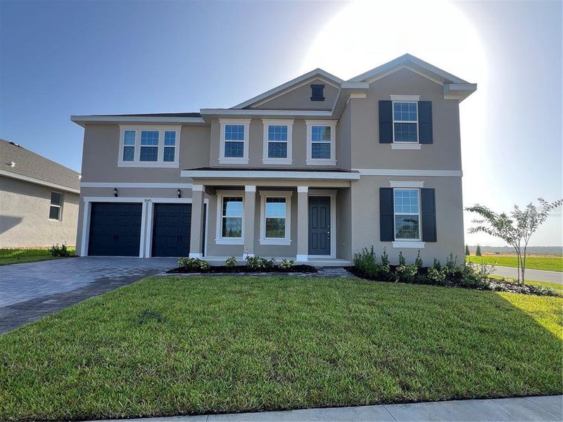 Front exterior of a new home in Hills of Minneola, Minneola, FL, highlighting curb appeal (Image 1).