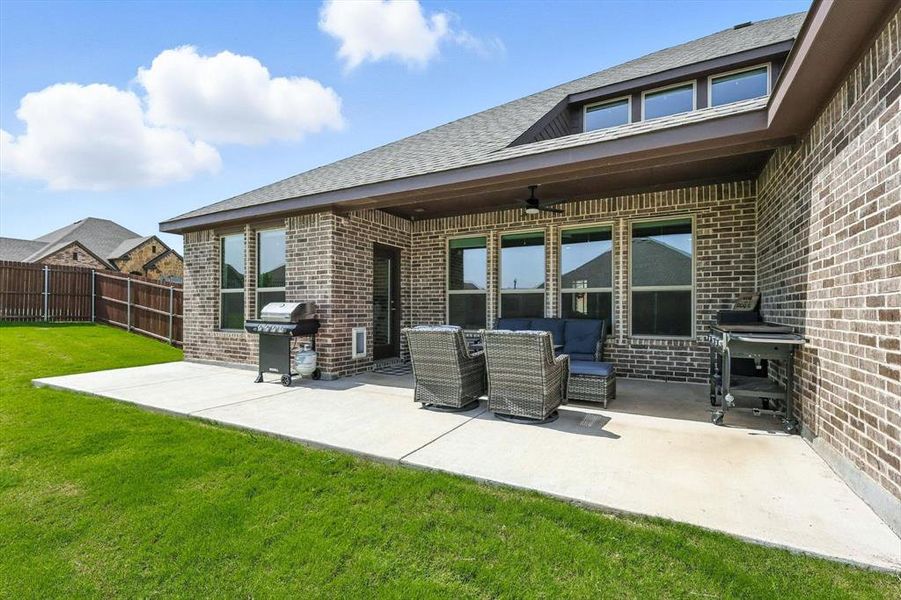 View of patio with area for grilling, a ceiling fan, and an outdoor hangout area