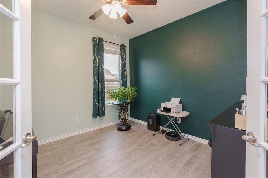 Misc room with ceiling fan and light hardwood / wood-style floors