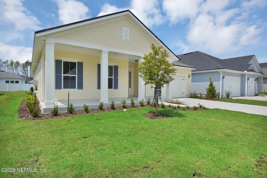 Front exterior of a new home in Forest Park at Wildlight, Yulee, FL, highlighting curb appeal (Image 2). Front exterior of a new home in Forest Park at Wildlight, Yulee, FL, highlighting curb appeal (Image 2).