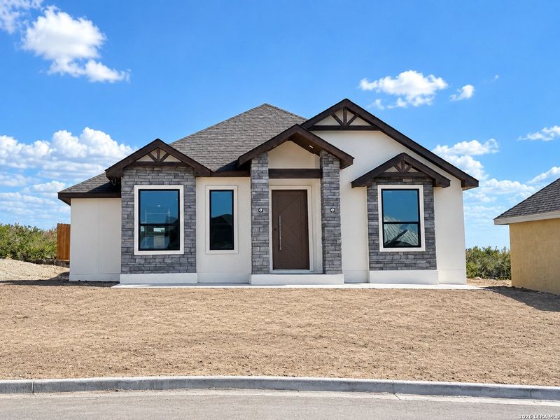 Front exterior of a new home in , Eagle Pass, TX, highlighting curb appeal (Image 2). Front exterior of a new home in , Eagle Pass, TX, highlighting curb appeal (Image 2).