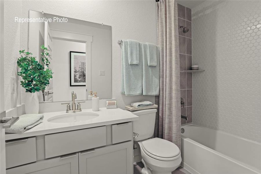 Full bathroom featuring toilet, shower / tub combo with curtain, and vanity