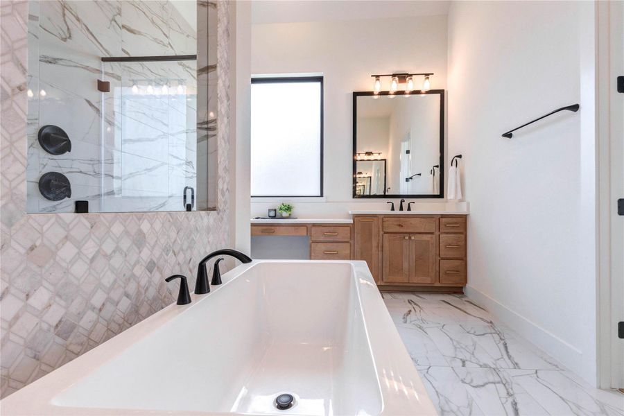 This modern bathroom features a luxurious freestanding tub, a spacious walk-in shower with elegant tilework, and a double vanity with ample storage. It boasts a sleek, contemporary design with stylish fixtures and abundant natural light. This modern bathroom features a luxurious freestanding tub, a spacious walk-in shower with elegant tilework, and a double vanity with ample storage. It boasts a sleek, contemporary design with stylish fixtures and abundant natural light.