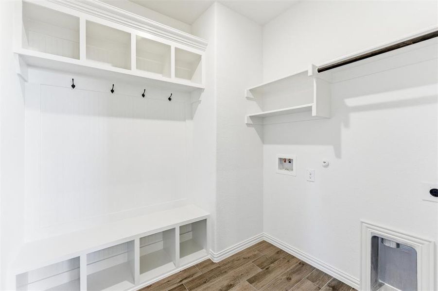 Mudroom with wood finish floors and baseboards