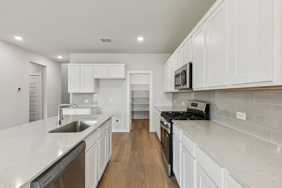 Kitchen in the Winters home plan by Trophy Signature Homes – REPRESENTATIVE PHOTO Kitchen in the Winters home plan by Trophy Signature Homes – REPRESENTATIVE PHOTO