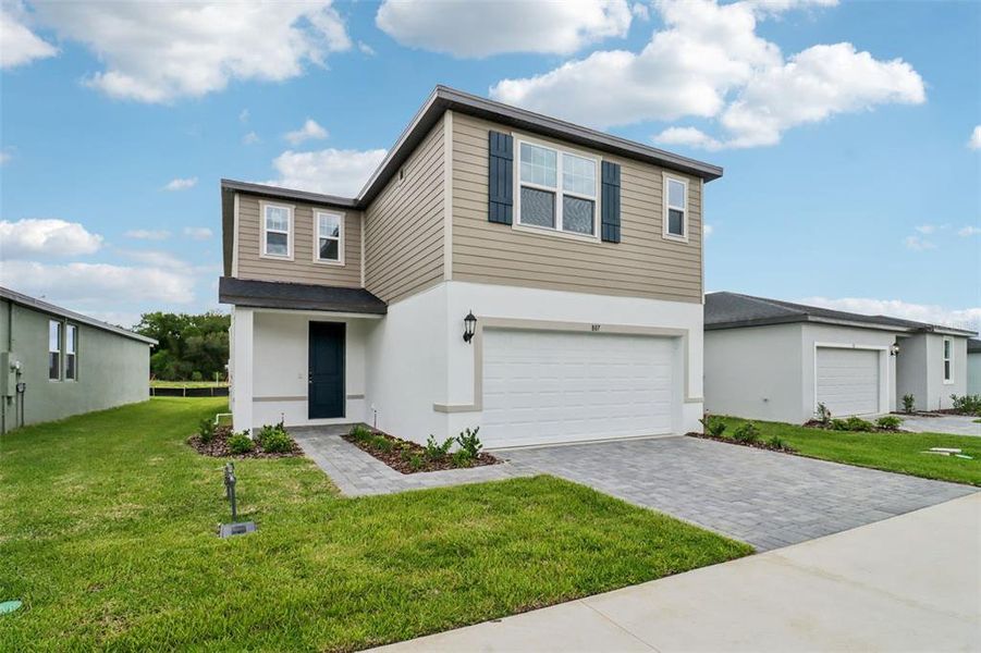 Front exterior of a new home in The Reserve at Hammock Oaks - Classic Series, Lady Lake, FL, highlighting curb appeal (Image 20). Front exterior of a new home in The Reserve at Hammock Oaks - Classic Series, Lady Lake, FL, highlighting curb appeal (Image 20).